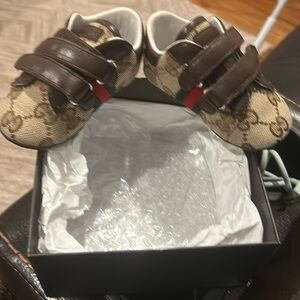 Gucci baby soft cushioned shoe with Velcro straps.